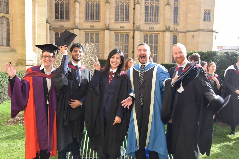 Graduates of MSc in Innovation and Entrepreneurship looking happy in the sun outside after graduation ceremony
